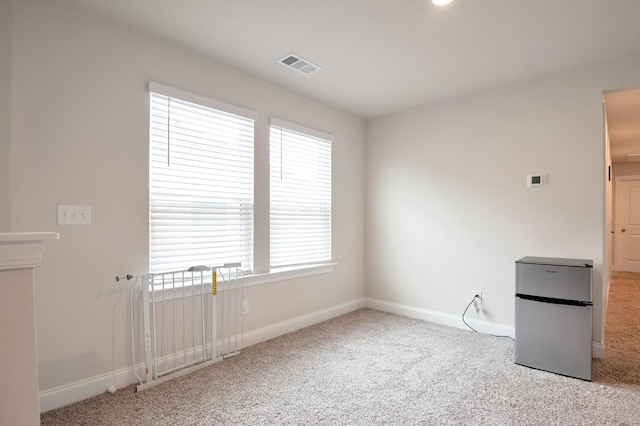 unfurnished room with light carpet