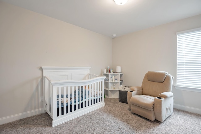 bedroom featuring a crib and carpet floors