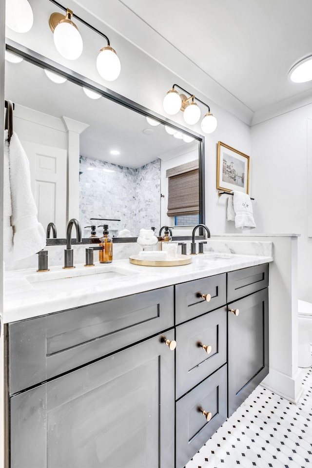 bathroom with vanity, ornamental molding, and toilet