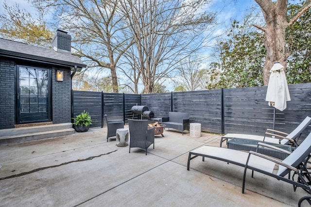 view of patio / terrace with a grill and a fire pit