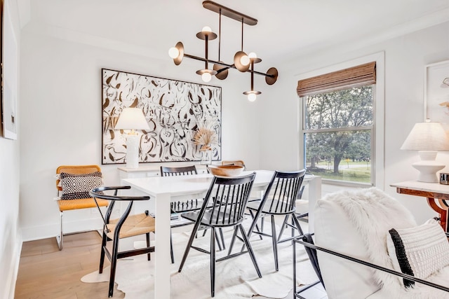 dining area with a chandelier and light hardwood / wood-style floors