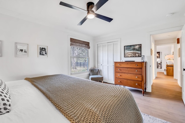 bedroom with ceiling fan, a closet, and light wood-type flooring