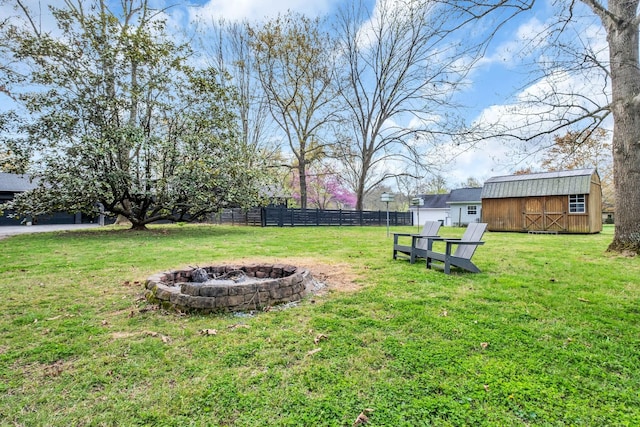 view of yard with a fire pit and a storage unit