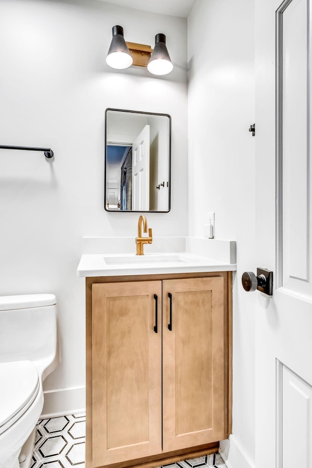 bathroom featuring vanity and toilet