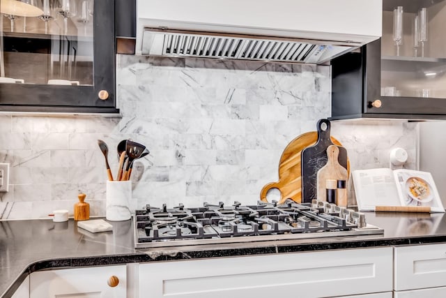 kitchen with white cabinetry, tasteful backsplash, stainless steel gas cooktop, and premium range hood