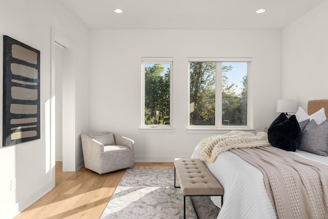 bedroom featuring light hardwood / wood-style floors and multiple windows