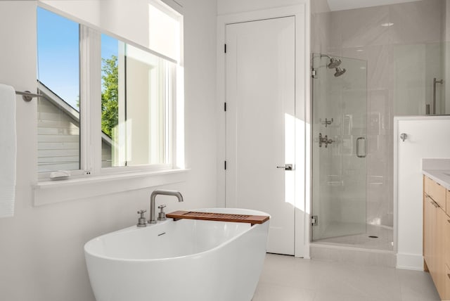 bathroom featuring vanity, tile patterned floors, and plus walk in shower