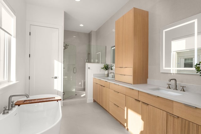 bathroom with tile patterned floors, vanity, and independent shower and bath