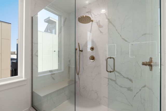 bathroom featuring a shower with shower door