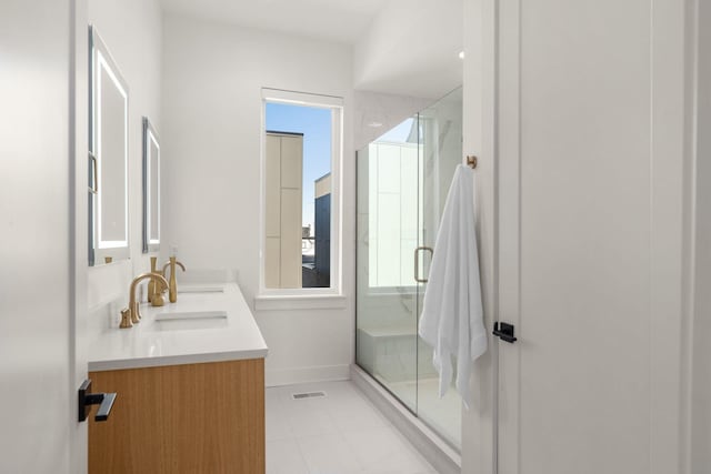 bathroom with vanity, an enclosed shower, and tile patterned floors