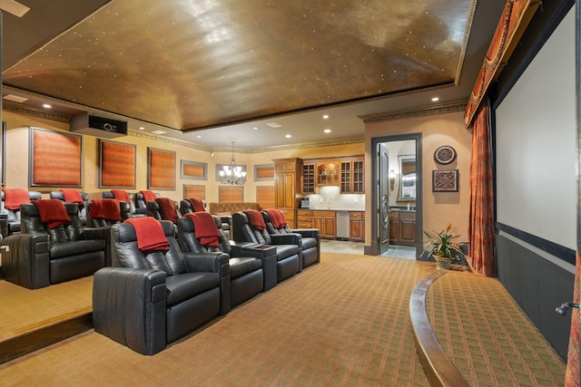 cinema room with an inviting chandelier, ornamental molding, and a raised ceiling