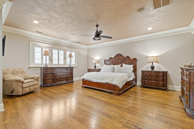 bedroom with ceiling fan, ornamental molding, and light hardwood / wood-style flooring