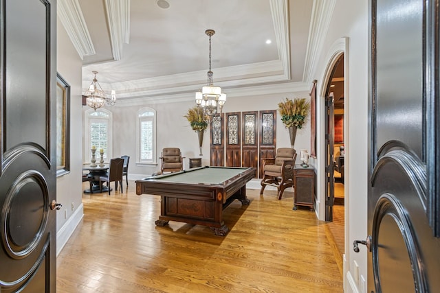 playroom featuring a raised ceiling, crown molding, pool table, and light hardwood / wood-style floors