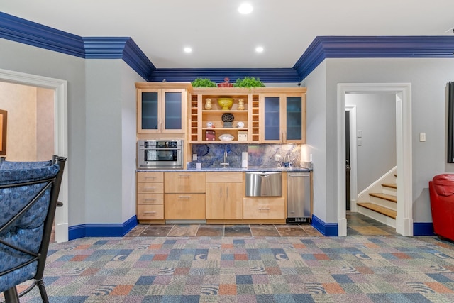 bar with light brown cabinetry, decorative backsplash, crown molding, and oven