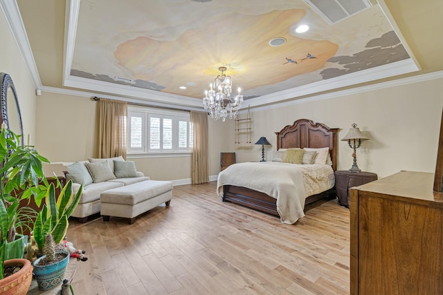 bedroom featuring an inviting chandelier, ornamental molding, a raised ceiling, and hardwood / wood-style floors