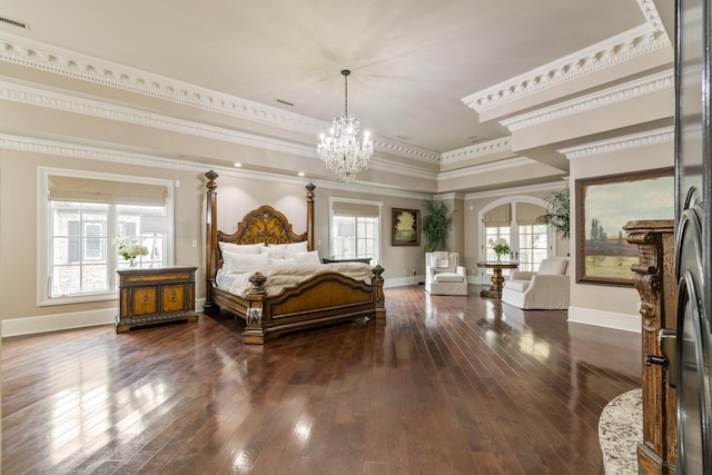 bedroom featuring dark hardwood / wood-style floors, stainless steel fridge, a tray ceiling, crown molding, and an inviting chandelier