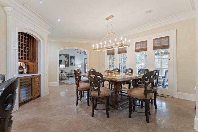 dining room with an inviting chandelier, crown molding, and beverage cooler