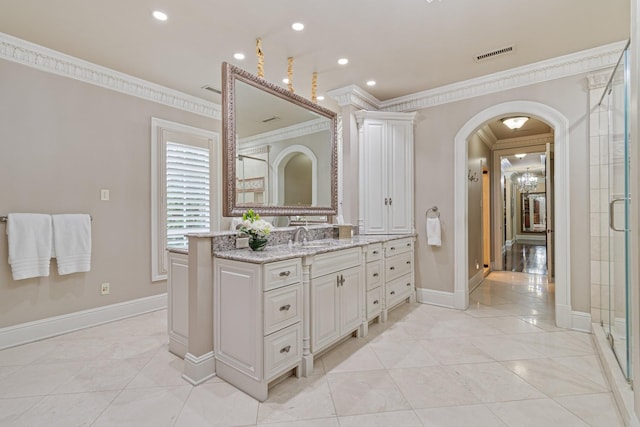 bathroom with vanity, crown molding, tile patterned floors, and walk in shower