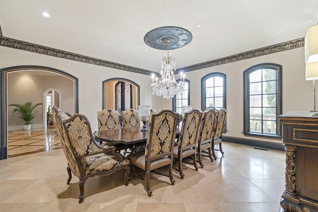 dining area featuring a notable chandelier and crown molding