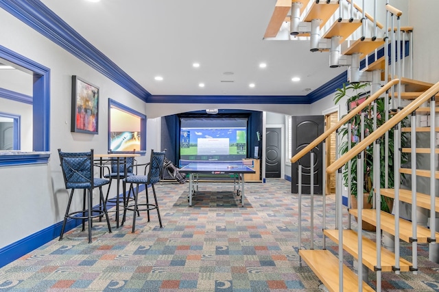 game room with ornamental molding and carpet floors