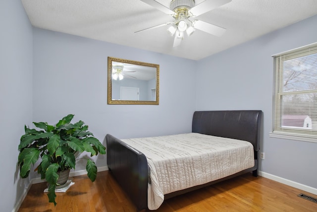 bedroom featuring hardwood / wood-style flooring and ceiling fan