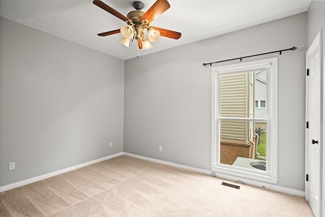 unfurnished room with ceiling fan and light carpet