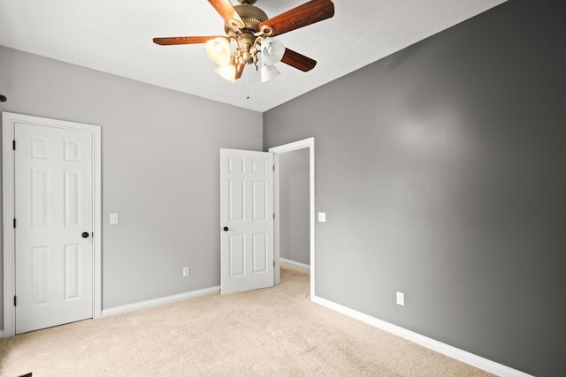 unfurnished bedroom featuring light carpet and ceiling fan