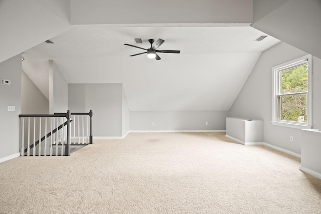 additional living space with light carpet, vaulted ceiling, and ceiling fan