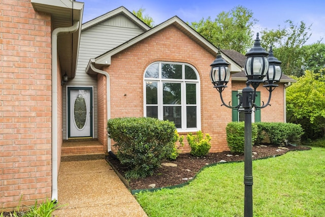 property entrance with a yard