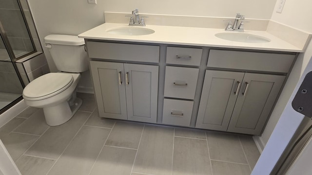 bathroom with vanity, toilet, and an enclosed shower