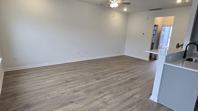 interior space with dark wood-type flooring, ceiling fan, and sink