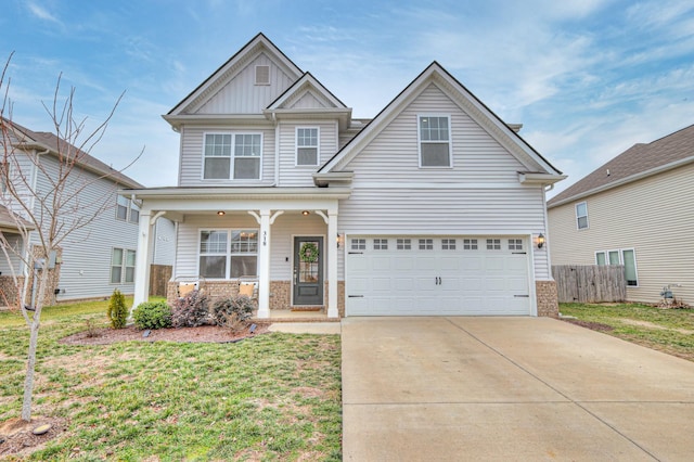 craftsman inspired home featuring a garage, a front lawn, and a porch