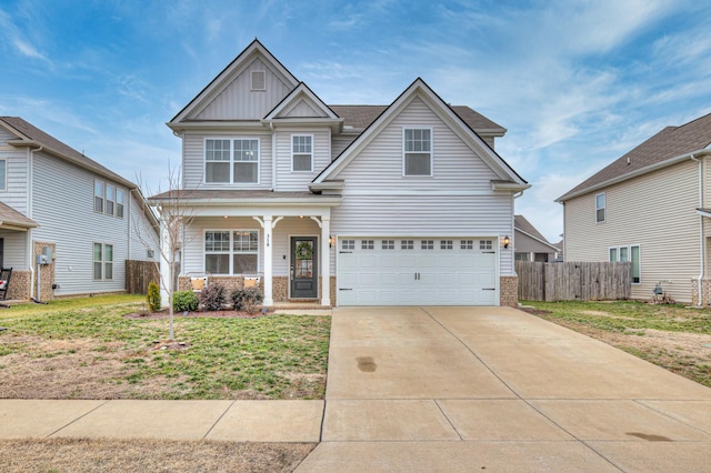 craftsman-style home with a garage, covered porch, and a front yard