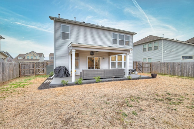 back of property featuring an outdoor living space, a yard, and a patio