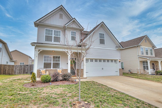 view of front of property with a garage, covered porch, and a front lawn