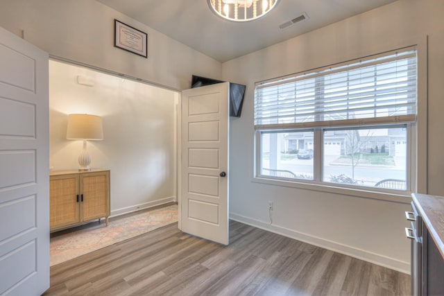 unfurnished bedroom featuring light wood-type flooring