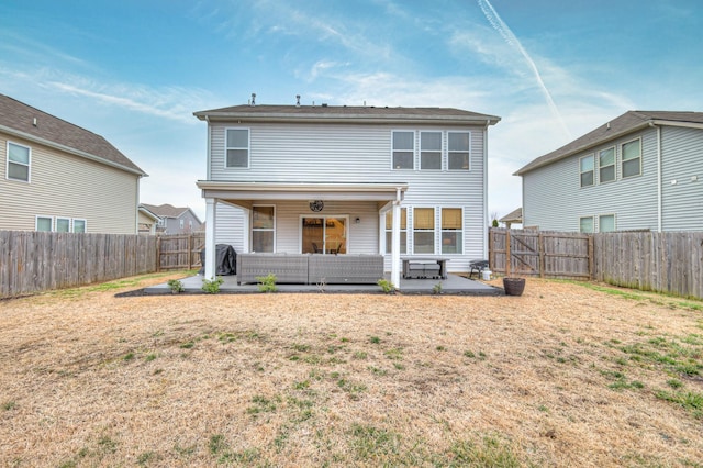 rear view of property featuring an outdoor hangout area and a patio area