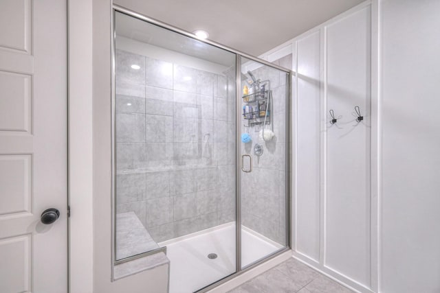 bathroom with tile patterned flooring and an enclosed shower