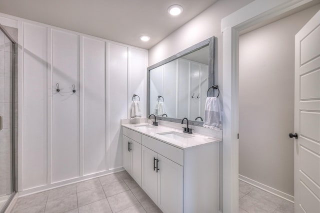 bathroom with vanity, a shower with shower door, and tile patterned flooring