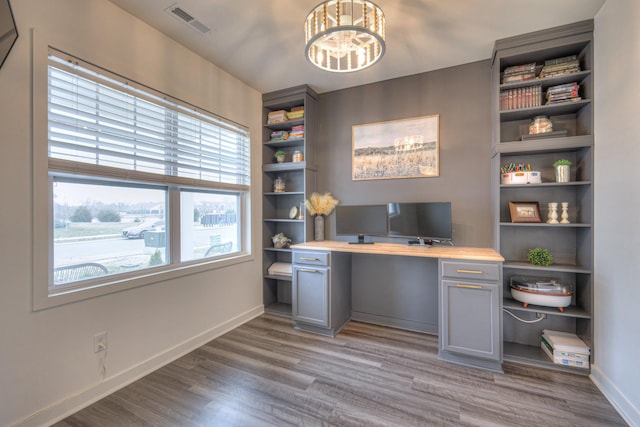 home office featuring hardwood / wood-style flooring and a chandelier