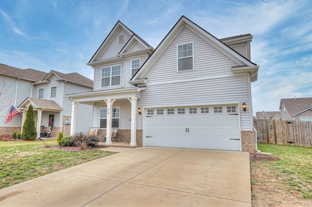 craftsman-style house featuring a garage, a front yard, and covered porch