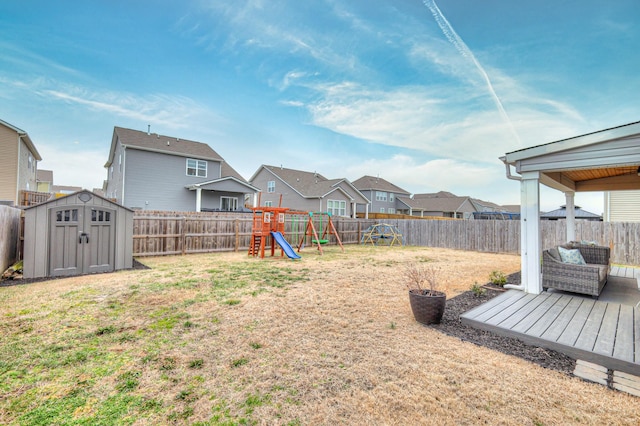 view of yard featuring a playground and a shed