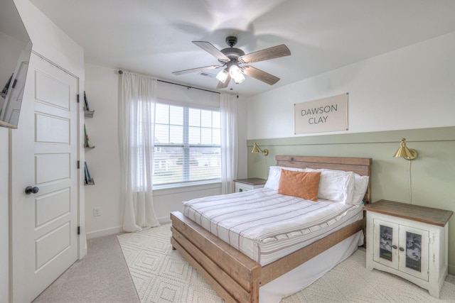 bedroom featuring light colored carpet and ceiling fan