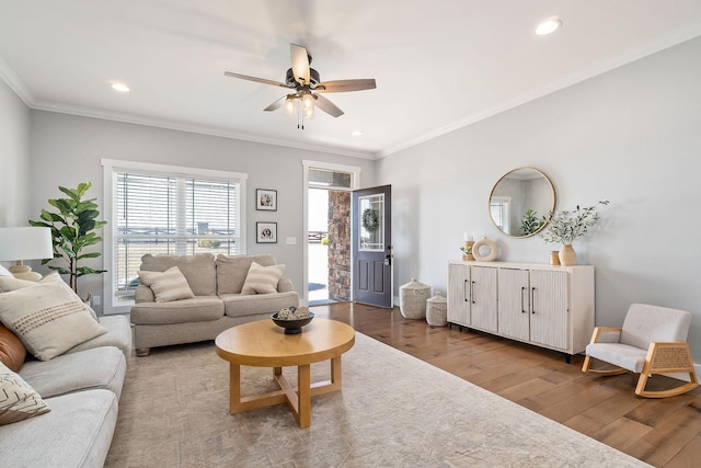 living room featuring crown molding, wood-type flooring, and ceiling fan