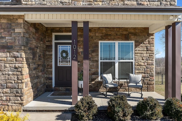 view of exterior entry featuring a porch