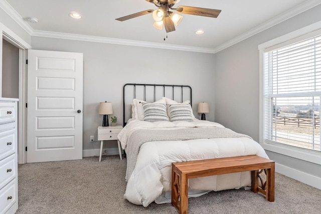 bedroom with ceiling fan, ornamental molding, and carpet floors