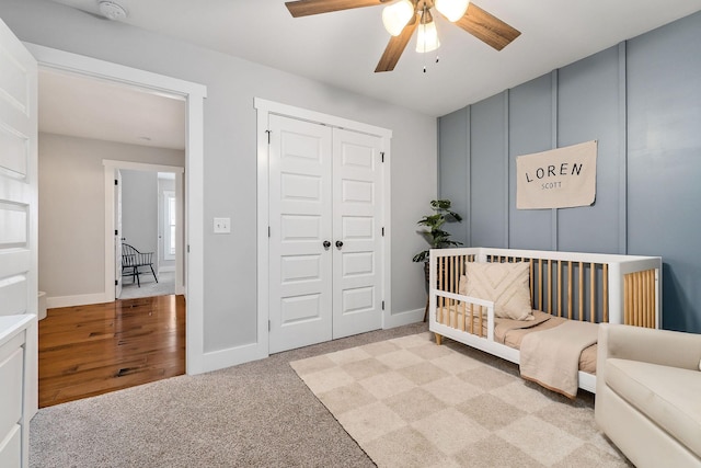 bedroom featuring ceiling fan, a closet, and light carpet