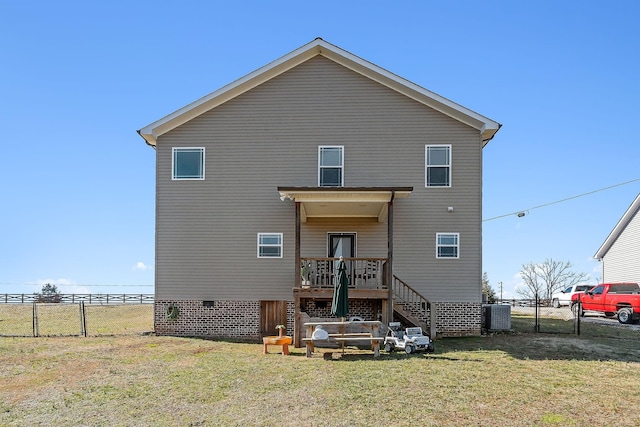 rear view of house with a lawn and central air condition unit