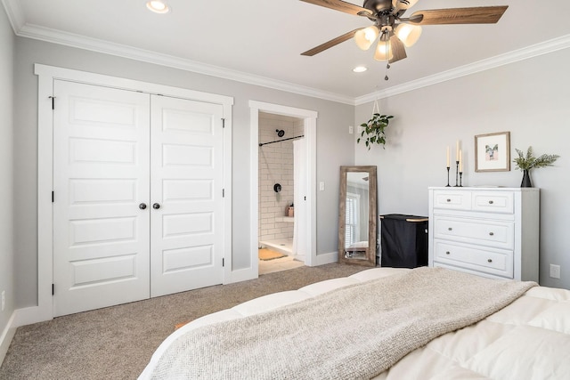 carpeted bedroom featuring ornamental molding, ensuite bathroom, ceiling fan, and a closet