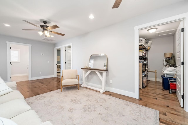 living room with hardwood / wood-style flooring and ceiling fan